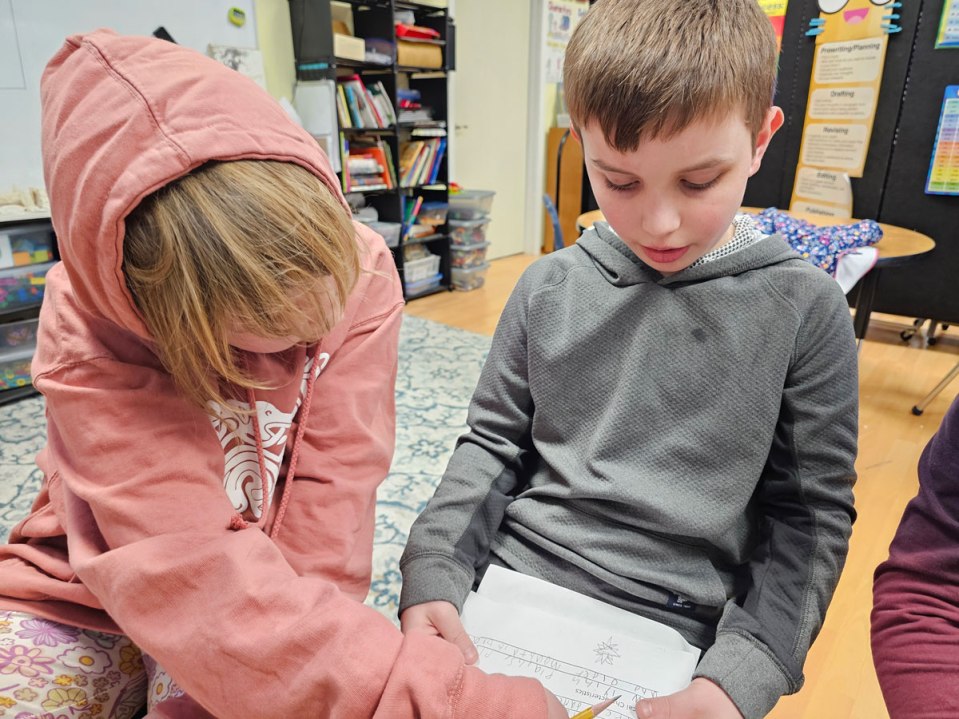 Girl helping a boy read